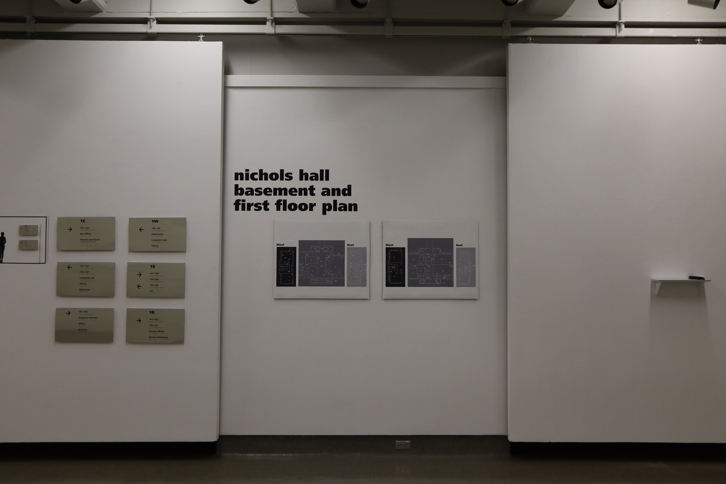 Exhibition gallery view with wall signage panels